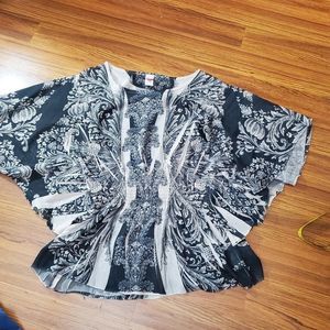 Rouge nude colored sheer club blouse q doleman sleeves and flounce waistline.